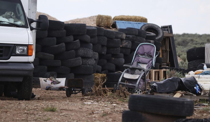 This Aug. 5, 2018 photo shows debris outside the location where people camped near Amalia, N.M. Three women believed to be the mothers of 11 children found hungry and living in a filthy makeshift compound in rural northern New Mexico have been arrested, following the weekend arrests of two men, authorities said Monday, Aug. 6. (Jesse Moya/Santa Fe New Mexican via AP)