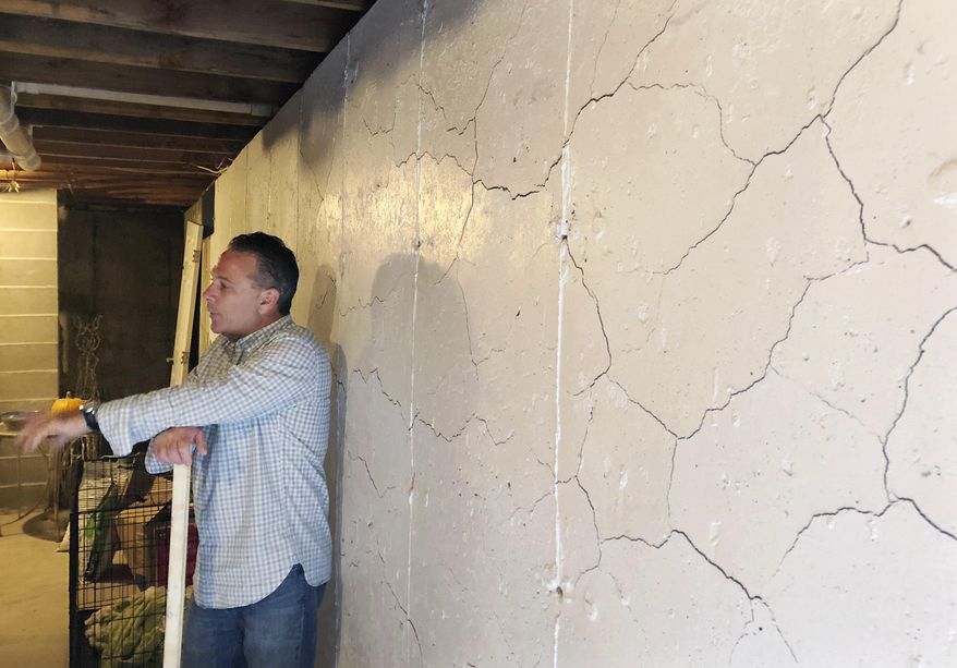 Homeowner Tim Hein stands in his basement, Monday, Aug. 6, 2018, in Willington, Conn., talking about how his foundation is cracking and crumbling due to the presence of an iron sulfide mineral in the concrete. A steady stream of political candidates has visited Heim's home prior to this year's election, promising they're the ones who can finally help the affected homeowners find a way to cover the massive cost of fixing their homes. (AP Photo/Susan Haigh)