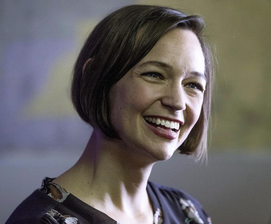 In a Thursday Feb.8, 2018 photo, Tabitha Isner, the Democratic candidate for Alabama's 2nd Congressional District, chats with supporters during the opening of her campaign headquarters in Montgomery, Ala. Isner said Monday, Aug. 6 that Russian hackers made more than a thousand attempts to break into her campaign website last month. (Mickey Welsh /The Montgomery Advertiser via AP)