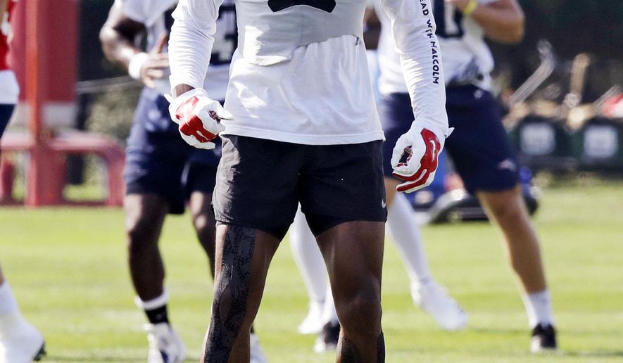 New England Patriots wide receiver Malcolm Mitchell jumps as he warms up on the practice field during the team's NFL football training camp in Foxborough, Mass., Friday, July 27, 2018. (AP Photo/Charles Krupa)