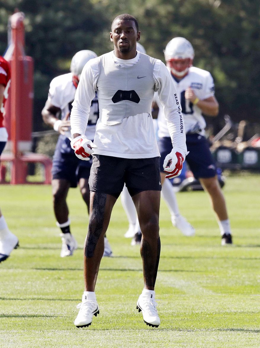New England Patriots wide receiver Malcolm Mitchell jumps as he warms up on the practice field during the team's NFL football training camp in Foxborough, Mass., Friday, July 27, 2018. (AP Photo/Charles Krupa)