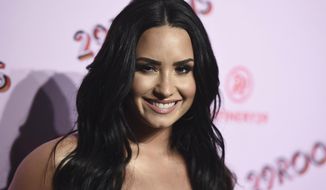FILE - In this Dec. 6, 2017 file photo, Demi Lovato arrives at the West Coast debut of 29rooms at ROW DTLA in Los Angeles. Lovato has checked out of the hospital she was rushed to two weeks ago for a reported overdose. A person close to Lovato says she was released from Cedars-Sinai hospital in Los Angeles over the weekend.  Lovato was hospitalized on July 24. (Photo by Jordan Strauss/Invision/AP, File)