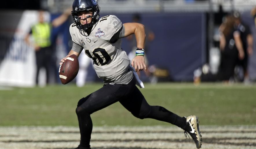 FILE - In this Dec. 2, 2017, file photo, Central Florida quarterback McKenzie Milton scrambles during the second half of the American Athletic Conference championship NCAA college football game against Memphis, in Orlando, Fla. New coach and former Missouri offensive coordinator Josh Heupel inherits a group that includes star quarterback McKenzie Milton, who is making sure the Knights enter this season with the right attitude. (AP Photo/John Raoux, File)