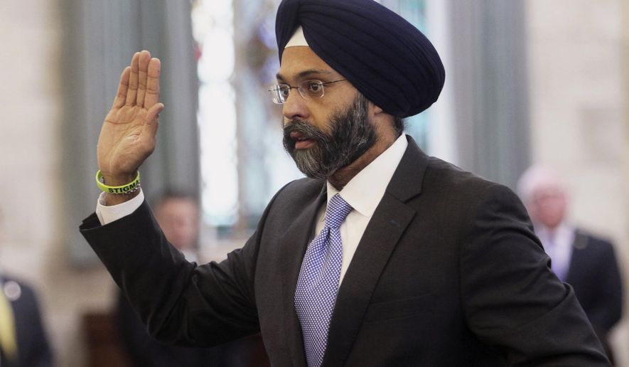 FILE - In this Jan. 16, 2018, file photo, Gurbir Grewal is sworn in before testifying in front of the senate judiciary committee in Trenton, N.J. WKXW-FM hosts Dennis Malloy and Judi Franco, the hosts of a popular New Jersey radio show suspended for calling Grewal, the nation's first Sikh attorney general "turban man," are back on the air Monday, Aug. 6, after a 10-day suspension. (Chris Pedota /The Record via AP, File)