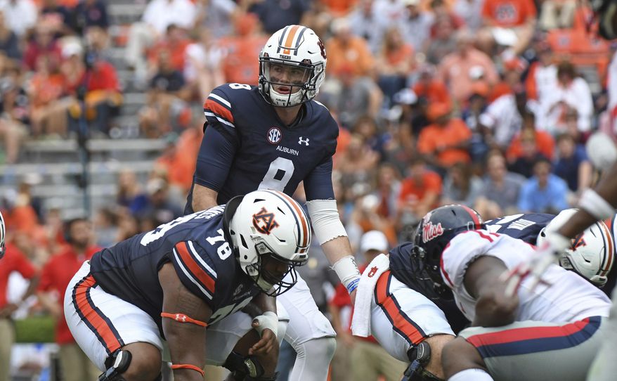 FILE - In this Oct. 7, 2017, file photo, Auburn quarterback Jarrett Stidham (8) looks to the sideline during the second half of an NCAA college football game against Mississippi, in Auburn, Ala. Last season scoring was down in college football, a drop of about a point and a half per game per team to 28.8, and the lowest mark since 2011 (28.3). But a deeper look into the numbers shows that defensive coordinators don't have much to celebrate. Offenses are still performing at a high level. They were, generally, just operating more slowly in 2017. And there is reason to believe this is the new normal as the allure of playing fast. (AP Photo/Thomas Graning, File)