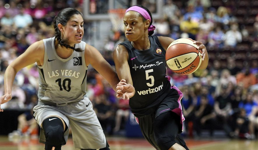 Connecticut Sun guard Jasmine Thomas (5) drives past Las Vegas Aces guard Kelsey Plum (10) in the first half half of WNBA basketball game action Sunday, Aug. 5, 2018, in Uncasville, Conn. (Sean D. Elliot/The Day via AP) **FILE**