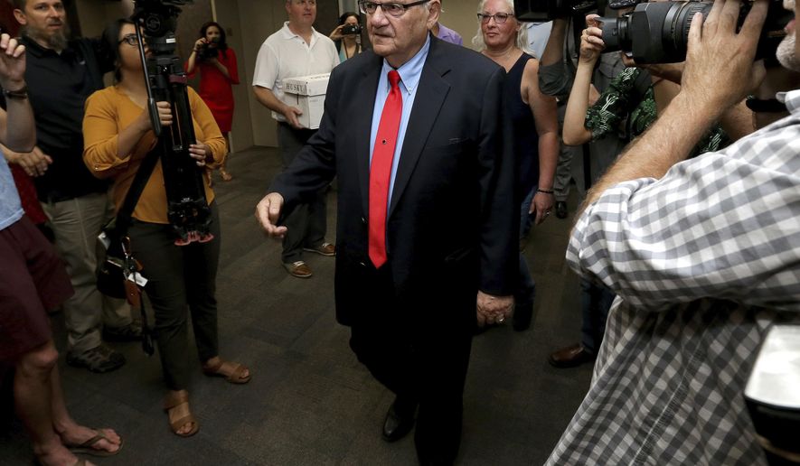 FILE - In this May 22, 2018 file photo, former Arizona Sheriff Joe Arpaio arrives at the Arizona Secretary of State's office in Phoenix, to turn in petition signatures in his bid to appear on the ballot in the race to succeed retiring U.S. Sen. Jeff Flake. County officials in metro Phoenix voted recently to ask the U.S. Supreme Court to review a ruling that concluded the county is liable for Arpaio's actions in cracking down on immigrants during traffic stops. The county's top prosecutor says the goal is to correct decisions that misapplied laws over which government agencies are the proper targets in lawsuits. (AP Photo/Matt York, File)