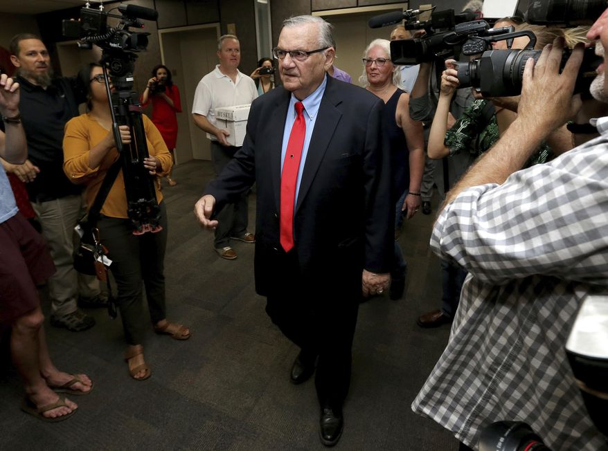 FILE - In this May 22, 2018 file photo, former Arizona Sheriff Joe Arpaio arrives at the Arizona Secretary of State's office in Phoenix, to turn in petition signatures in his bid to appear on the ballot in the race to succeed retiring U.S. Sen. Jeff Flake. County officials in metro Phoenix voted recently to ask the U.S. Supreme Court to review a ruling that concluded the county is liable for Arpaio's actions in cracking down on immigrants during traffic stops. The county's top prosecutor says the goal is to correct decisions that misapplied laws over which government agencies are the proper targets in lawsuits. (AP Photo/Matt York, File)