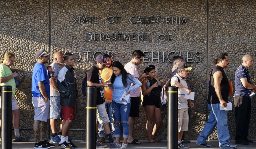 People line up at the California Department of Motor Vehicles prior to opening in the Van Nuys section of Los Angeles on Tuesday, Aug. 7, 2018. California lawmakers are seeking answers from the Department of Motor Vehicles about hours-long wait times that have prompted public outcry. Assemblyman Phil Ting will lead a hearing Tuesday afternoon to question DMV officials about what they are doing to reduce wait times amid reports that many Californians have to wait hours to renew their licenses. (AP Photo/Richard Vogel)