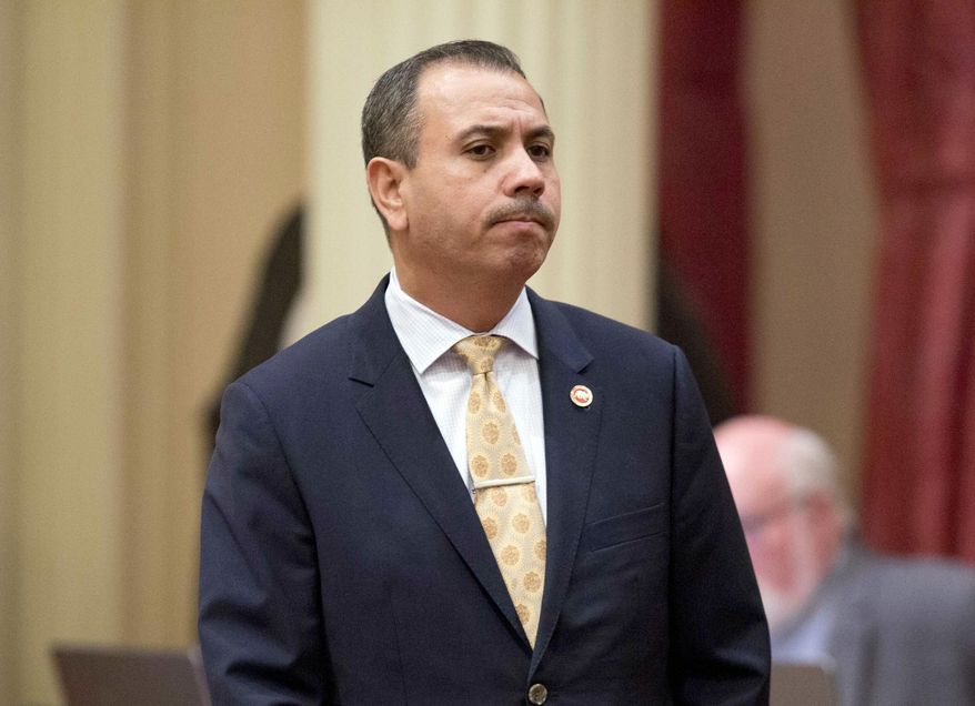 FILE - In this Jan. 3, 2018, file photo, state Sen. Tony Mendoza, D-Artesia, stands at his desk after announcing that he will take a month-long leave of absence while an investigation into sexual misconduct allegations against him are completed, in Sacramento, Calif. Voters in parts of Los Angeles and Orange counties go to the polls Tuesday, Aug. 7, 2018, to replace Mendoza, who resigned in February over the sexual misconduct allegations. (AP Photo/Steve Yeater, File)