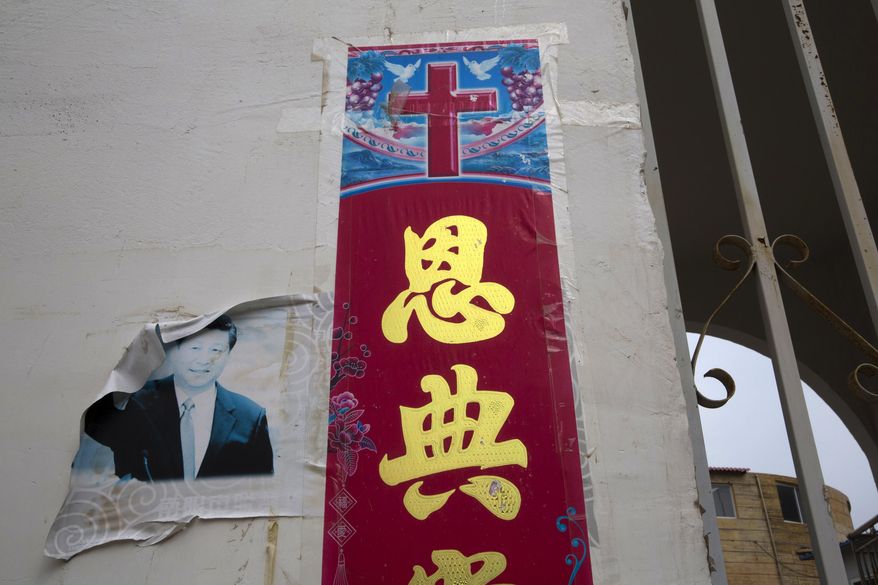 In this photo taken Friday, June 1, 2018, a faded photo of Chinese President Xi Jinping is seen near the Christian poster with the word &amp;quot;Grace&amp;quot; outside a house church near Nanyang in central China&#39;s Henan province. Under President Xi Jinping, China&#39;s most powerful leader since Mao Zedong, believers are seeing their freedoms shrink dramatically even as the country undergoes a religious revival. Experts and activists say that as he consolidates his power, Xi is waging the most severe systematic suppression of Christianity in the country since religious freedom was written into the Chinese constitution in 1982. (AP Photo/Ng Han Guan)