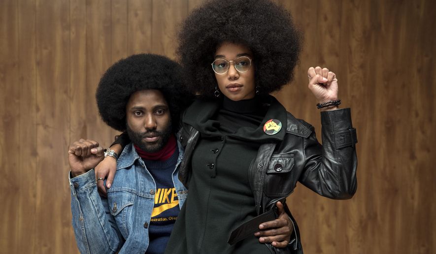 This image released by Focus Features shows John David Washington, left, and Laura Harrier in a scene from "BlacKkKlansman." (David Lee/Focus Features via AP)
