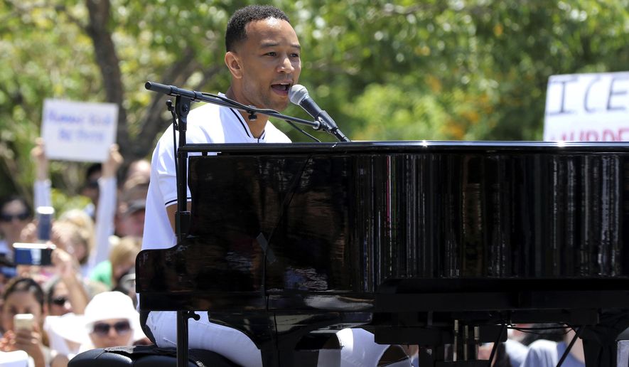 FILE - In this June 30, 2018, file photo, John Legend performs at the "Families Belong Together: Freedom for Immigrants" March in Los Angeles. Legend, Janet Jackson, The Weeknd and Shawn Mendes are among the artists slated to appear at the 2018 Global Citizen Festival. The event will take place on Sept. 29 on the Great Lawn in New York City’s Central Park. (Photo by Willy Sanjuan/Invision/AP, File)