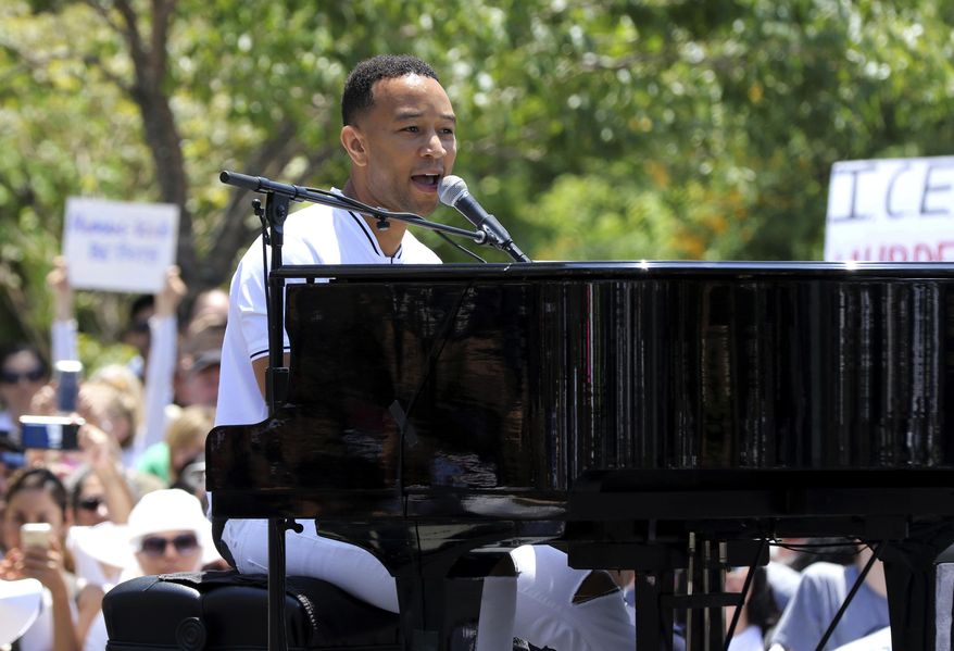 FILE - In this June 30, 2018, file photo, John Legend performs at the "Families Belong Together: Freedom for Immigrants" March in Los Angeles. Legend, Janet Jackson, The Weeknd and Shawn Mendes are among the artists slated to appear at the 2018 Global Citizen Festival. The event will take place on Sept. 29 on the Great Lawn in New York City’s Central Park. (Photo by Willy Sanjuan/Invision/AP, File)