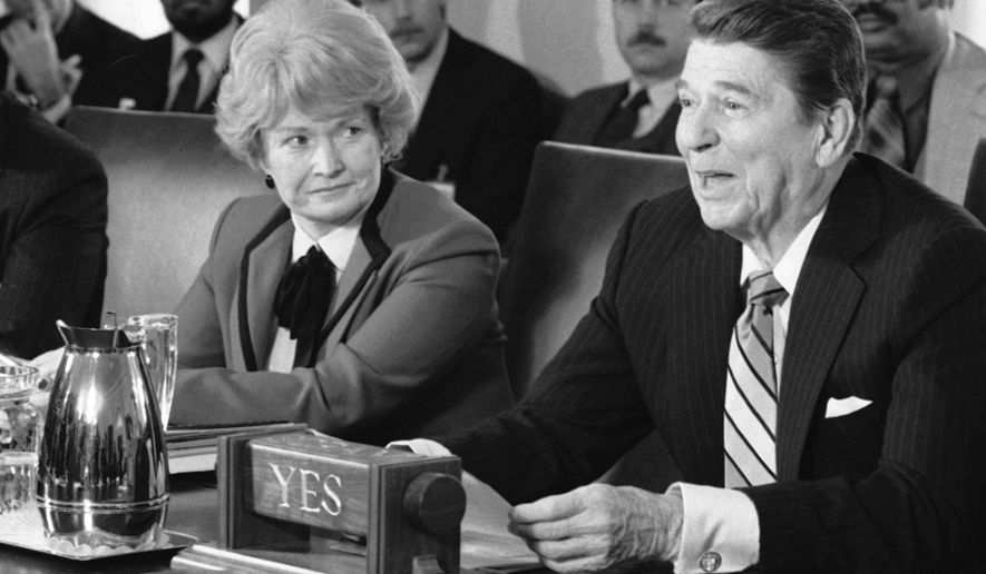 FILE - In this April 3, 1985 file photo, Health and Human Services Secretary Margaret Heckler, left, listens as President Ronald Reagan talks to about child safety to a group of missing and exploited children activists in the Cabinet Room of the White House in Washington. Heckler, an eight-term Republican congresswoman from Massachusetts, secretary of Health and Human Services under Reagan, and U.S. ambassador to Ireland, died Monday, Aug. 6, 2018, in Arlington, Va. She was 87. (AP Photo/Barry Thumma, File)