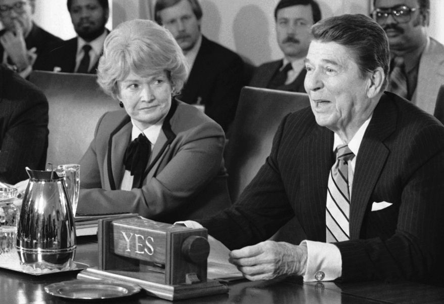 FILE - In this April 3, 1985 file photo, Health and Human Services Secretary Margaret Heckler, left, listens as President Ronald Reagan talks to about child safety to a group of missing and exploited children activists in the Cabinet Room of the White House in Washington. Heckler, an eight-term Republican congresswoman from Massachusetts, secretary of Health and Human Services under Reagan, and U.S. ambassador to Ireland, died Monday, Aug. 6, 2018, in Arlington, Va. She was 87. (AP Photo/Barry Thumma, File)