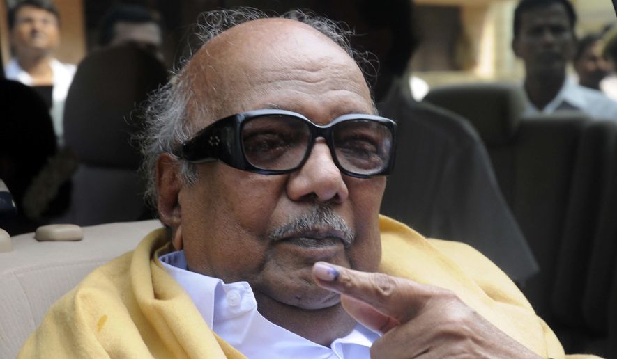 FILE- In this May 13, 2009 file photo, Tamil Nadu state's then Chief Minister Muthuvel Karunanidhi displays the indelible ink mark on his finger after casting his vote at a polling booth in Chennai, India. Karunanidhi, a scriptwriter-turned-politician in the southern Indian state of Tamil Nadu, has died after a prolonged illness. He was 94. (AP Photo, File)