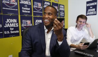 FILE - In this Aug. 6, 2018 file photo, Republican U.S. Senate candidate John James makes a campaign call at his headquarters in Livonia, Mich. Detroit-area businessman and Iraq War veteran John James has won the Republican nomination to run against Democratic Sen. Debbie Stabenow this fall. James, a political newcomer endorsed by President Donald Trump, defeated Sandy Pensler in Tuesday&#39;s primary. (AP Photo/Paul Sancya, File)