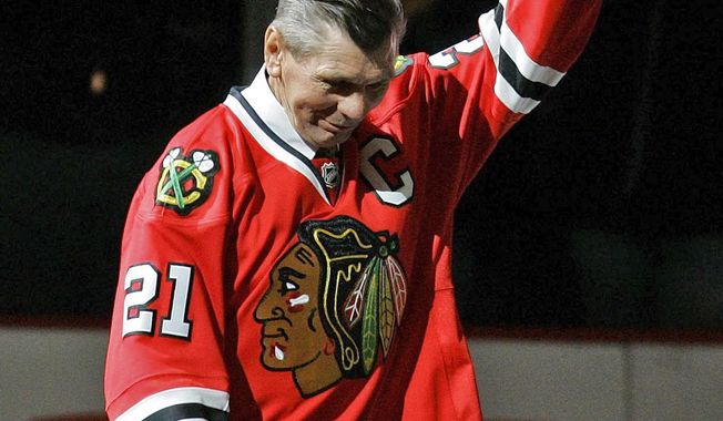FILE - In this March 7, 2008, file photo, Chicago Blackhawks great Stan Mikita waves to fans as they as he is introduced before an NHL hockey game against the San Jose Sharks in Chicago. Mikita, who played for the Blackhawks for 22 seasons, becoming one of the franchise&#x27;s most revered figures, has died, the Blackhawks announced Tuesday, Aug. 7, 2018. He was 78. (AP Photo/Brian Kersey, File)