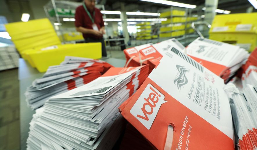 Empty envelopes from Washington state's primary election are shown stacked Tuesday, Aug. 7, 2018, at King County Election headquarters in Renton, Wash. This is the first time that voters state-wide did not need to put stamps on their ballots, as voters will decide which candidates advance to the November ballot in 10 congressional races, a U.S. Senate seat and dozens of legislative contests. (AP Photo/Ted S. Warren)