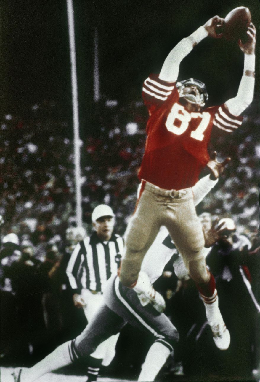 FILE - In this Jan. 10, 1982, file photo, San Francisco 49ers' Dwight Clark leaps high in the end zone to catch a touchdown pass late in the fourth quarter of the NFC championship NFL football game against the Dallas Cowboys at Candlestick Park in San Francisco. The 49ers will honor Clark with a season-long celebration of his life that will include unveiling a statue of "The Catch." Clark died in June at age 61. (Phil Huber/The Dallas Morning News via AP, File)