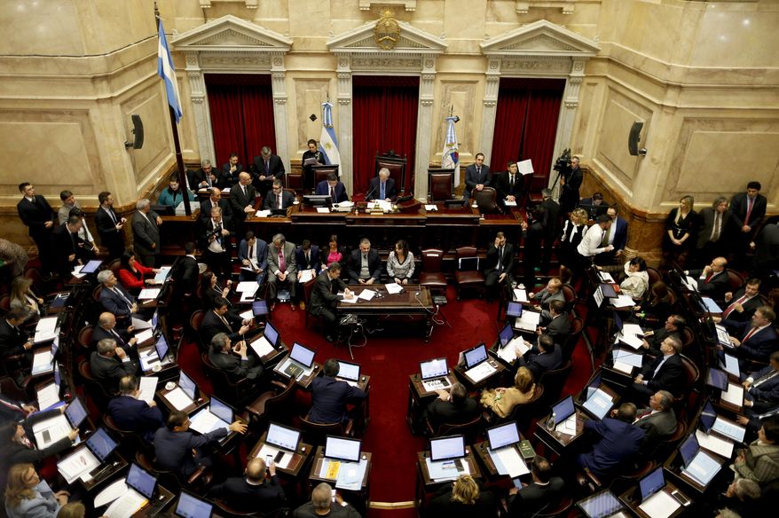 Argentina's Senate take their places ahead of a debate on a legislation that would decriminalize abortions in Buenos Aires, Argentina Wednesday, Aug. 8, 2018. Following months of increasingly tense debate, lawmakers in Argentina meet in Congress on Wednesday ahead of a vote on a bill that would decriminalize abortions up to the first 14 weeks of pregnancy.(AP Photo/Natacha Pisarenko)