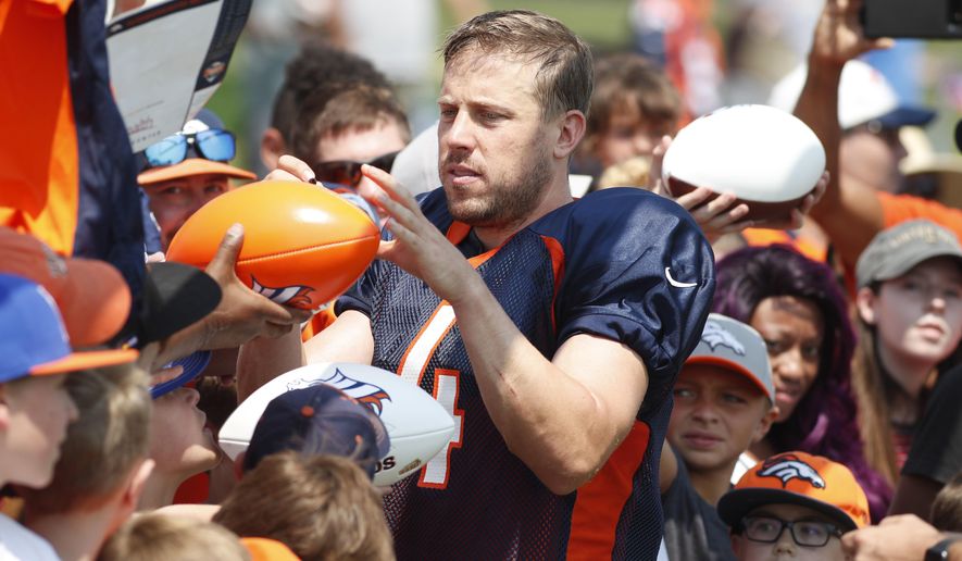Denver Broncos quarterback Case Keenum signs autographs at NFL football training camp Tuesday, Aug. 7, 2018, in Englewood, Colo. (AP Photo/David Zalubowski)