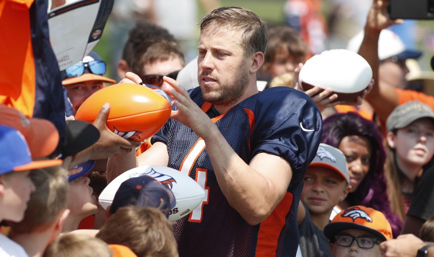 Denver Broncos quarterback Case Keenum signs autographs at NFL football training camp Tuesday, Aug. 7, 2018, in Englewood, Colo. (AP Photo/David Zalubowski)
