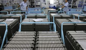 In this July 27, 2018, photo, workers transfer Lithium-ion batteries in a factory in Taizhou in east China&#39;s Jiangsu province. China&#39;s exports accelerated in July, showing little impact from a U.S. tariff hike, while sales to the United States rose 13.3 percent over a year earlier. (Chinatopix via AP)
