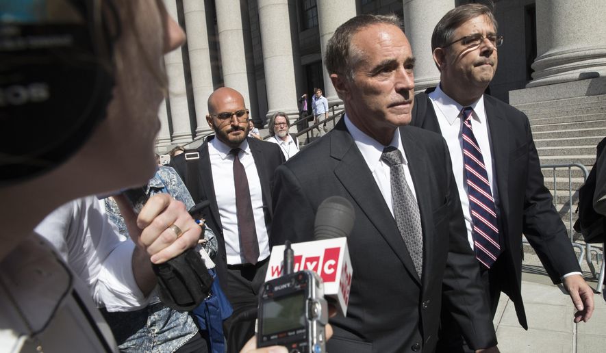 Republican U.S. Rep. Christopher Collins, center, is surrounded by reporters as he leaves federal court, Wednesday, Aug. 8, 2018, in New York. Rep. Collins of western New York state has been indicted on charges that he used inside information about a biotechnology company to make illicit stock trades (AP Photo/Mary Altaffer)