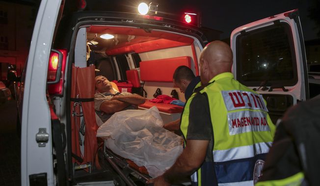 Injured person is taken to ambulance after a missile from Gaza Strip hit in the town of Sderot, Israel, Wednesday, Aug. 7, 2018. Sirens wailed in southern Israel warning of incoming projectiles from Gaza and Israeli media reported two people were lightly injured from shrapnel in the border town of Sderot. (AP photo/Yehuda Peretz)
