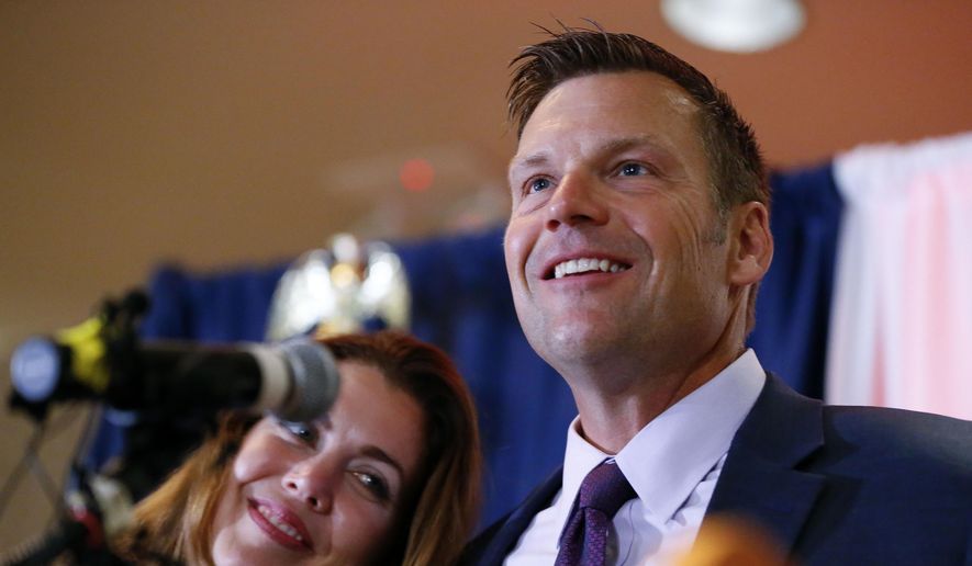 Kansas Republican gubernatorial candidate Kris Kobach and his wife Heather take the stage to thank their supporters and send them home for the night after problems with polls in Johnson County, Kan., delayed the final results until the early morning on Wednesday, Aug. 8, 2018, at the Capitol Plaza Hotel in Topeka, Kan. (Chris Neal/The Topeka Capital-Journal via AP)
