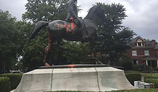 FILE - In this Aug. 14, 2017 file photo, a statue of a Confederate officer is seen splattered with orange paint near a park in Louisville, Ky. The vandalism was discovered a day after violence erupted at a white nationalist rally in Charlottesville, Va. Louisville Mayor Greg Fischer said in a tweet Wednesday, Aug. 8, 2018, the city will move statues honoring a Confederate soldier and a 19th-century editor known for anti-immigrant writings. (AP Photo/Claire Galofaro, File)