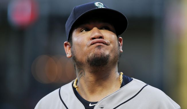 Seattle Mariners starting pitcher Felix Hernandez reacts after allowing a soft bunt-single by Texas Rangers&#x27; Carlos Tocci during the third inning of a baseball game Tuesday, Aug. 7, 2018, in Arlington, Texas. The Rangers won 11-4. (AP Photo/Brandon Wade)