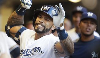 Milwaukee Brewers Eric Thames celebrates after hitting a home run during the first inning of a baseball game against the San Diego Padres Wednesday, Aug. 8, 2018, in Milwaukee. (AP Photo/Morry Gash)