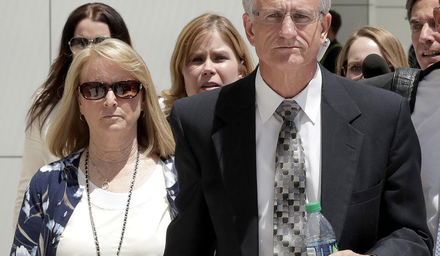 FILE - In this June 7, 2017, file photo, former Arizona Corporation Commissioner Gary Pierce, and his wife Sherry, left, leave court in Phoenix after being arraigned on bribery and fraud charges. Prosecutors said Tuesday, Aug. 7, 2018 that they are dropping the bribery case against Pierce, his wife and two others after their trial ended three weeks ago with a mistrial. (AP Photo/Matt York, File)