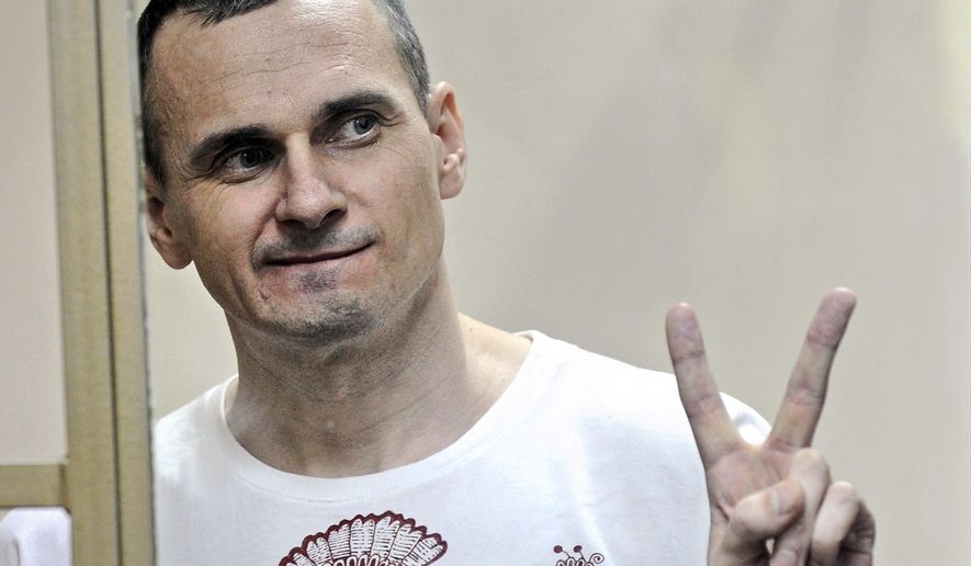 FILE - In this Tuesday, Aug. 25, 2015 file photo, Oleg Sentsov gestures as the verdict is delivered, as he stands behind bars at a court in Rostov-on-Don, Russia. The lawyer for a hunger-striking Ukrainian filmmaker imprisoned in Russia says his client has become increasingly frail. Wednesday, Aug. 8, 2018 marks the 87th day that Oleg Sentsov has been refusing food in a Russian prison. His lawyer Dmitry Dinze said after visiting him Tuesday that Sentsov has a very low hemoglobin level, resulting in anemia and a slow heartbeat of about 40 beats per minute. (AP Photo, file)