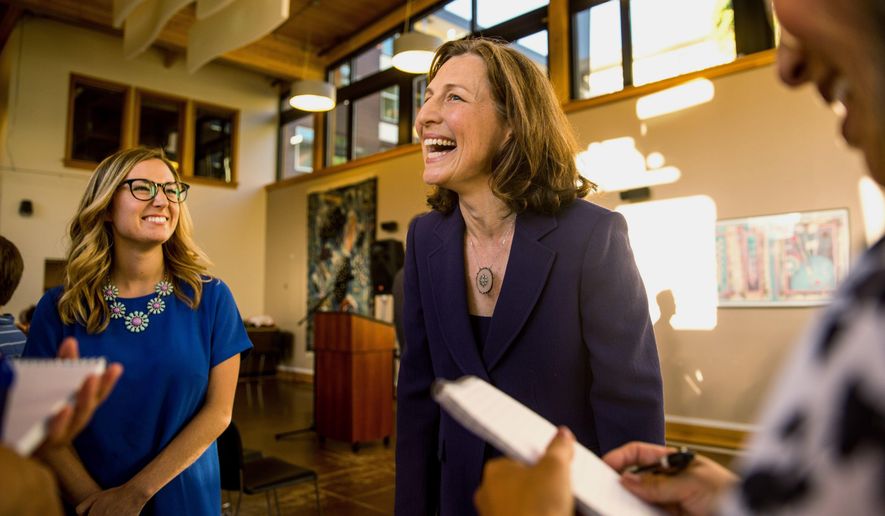 Eighth Congressional District Candidate Kim Schrier laughs about her hectic day while answering a swarm of questions at her election watch party at the YWCA in Issaquah, Wash., Tuesday, Aug. 7, 2018. (Rebekah Welch/The Seattle Times via AP)
