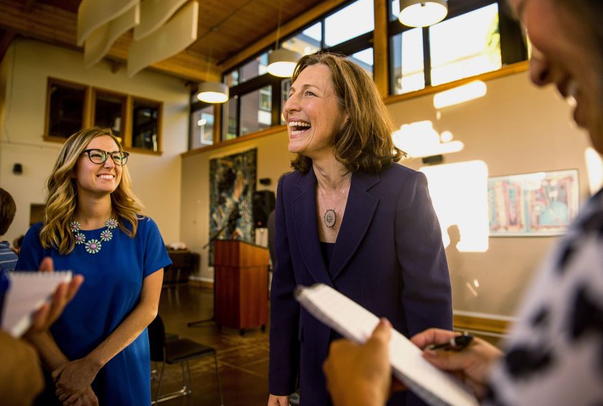 Eighth Congressional District Candidate Kim Schrier laughs about her hectic day while answering a swarm of questions at her election watch party at the YWCA in Issaquah, Wash., Tuesday, Aug. 7, 2018. (Rebekah Welch/The Seattle Times via AP)