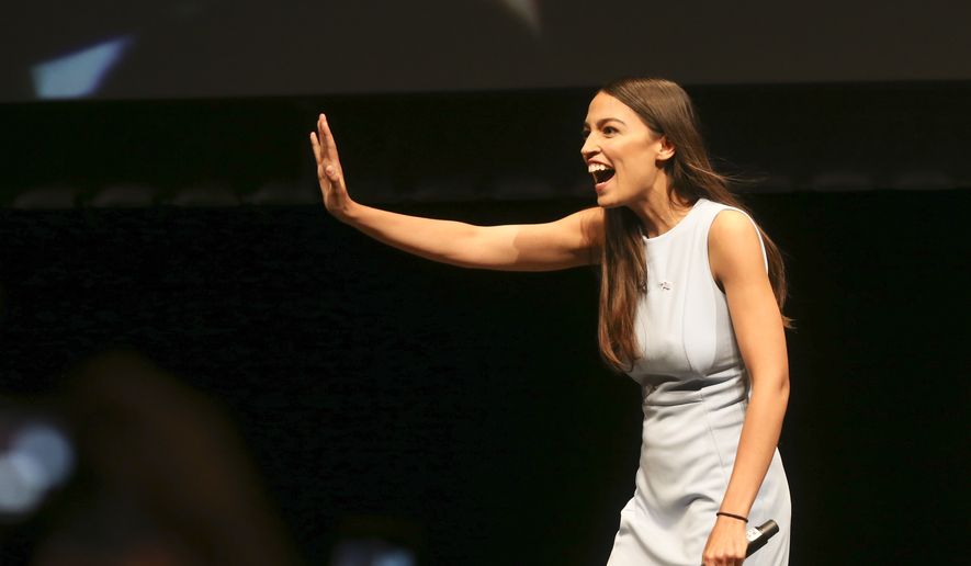 In this Friday, July 20, 2018, file photo, Alexandria Ocasio-Cortez, a Democratic congressional candidate from New York, waves during a rally, in Wichita, Kan. Ocasio-Cortez is trying to leverage the 17,000 votes that gave her a primary win in New York into a national movement. (Jaime Green/The Wichita Eagle via AP, File)