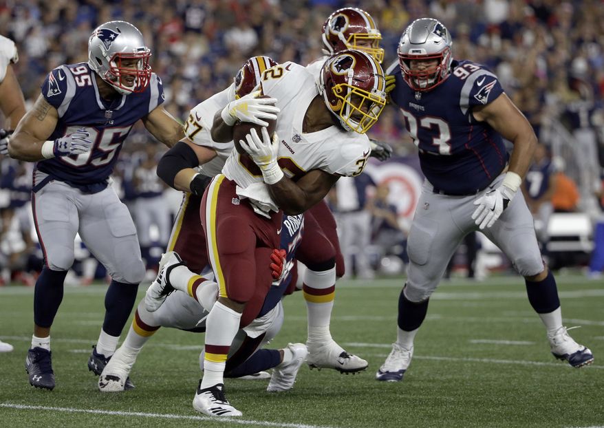 Washington Redskins running back Samaje Perine, center, gains yardage against the New England Patriots during the first half of a preseason NFL football game, Thursday, Aug. 9, 2018, in Foxborough, Mass. (AP Photo/Steven Senne) **FILE**