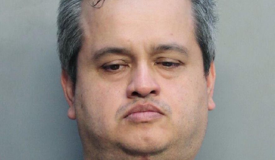 This Aug. 8, 2018, photo made available by the Miami-Dade Department of Corrections shows Sigman Hernandez under arrest. Hernandez pleaded guilty to stomping and chocking a Yorkshire Terrier and leaving the dog to die outside a supermarket. Sigma agreed to spend 270 days in jail for the 2017 death of the dog. (Miami-Dade Department of Corrections via AP)