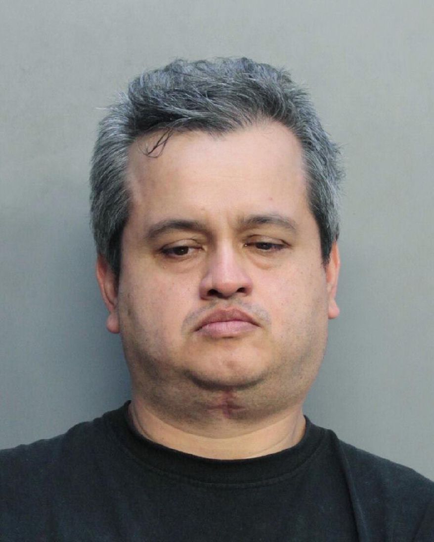 This Aug. 8, 2018, photo made available by the Miami-Dade Department of Corrections shows Sigman Hernandez under arrest. Hernandez pleaded guilty to stomping and chocking a Yorkshire Terrier and leaving the dog to die outside a supermarket. Sigma agreed to spend 270 days in jail for the 2017 death of the dog. (Miami-Dade Department of Corrections via AP)