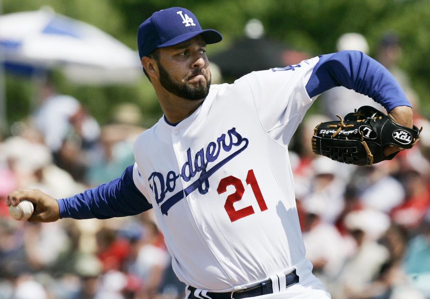 FILE - In this Friday, March 14, 2008, file photo, Los Angeles Dodgers starting pitcher Esteban Loaiza pitches to St. Louis Cardinals' Cesar Izturis during the first inning of a spring training baseball game in Vero Beach, Fla. Former All-Star pitcher Loaiza has pleaded guilty to possession of about 20 kilograms of cocaine with intent to distribute. The 46-year-old acknowledged in a San Diego courtroom Friday, Aug. 10, 2018, that he possessed about 20 kilograms (44 pounds) of cocaine with intent to distribute. He faces up to life in prison when he is sentenced Nov. 2. Loaiza had been under surveillance when he was arrested in February near a house in Imperial Beach, which borders Tijuana, Mexico. His sliver Mercedes SUV had just left the garage when authorities stopped him. (AP Photo/Orlin Wagner, File)