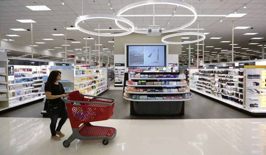 In this May 30, 2018, file photo, a shopper walks through the updated cosmetic department at a Target store in San Antonio. (AP Photo/Eric Gay, File)