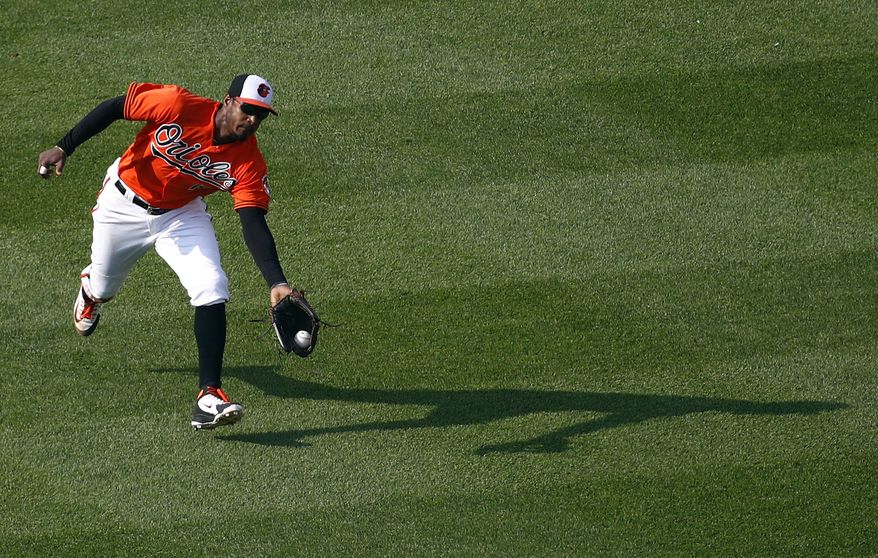 FILE - In this May 12, 2018, file photo, Baltimore Orioles center fielder Adam Jones catches a fly ball that was hit by Tampa Bay Rays' Brad Miller to end the top of the eighth inning of the first baseball game of a doubleheader in Baltimore. Jones will move to right field to make room for rookie Cedric Mullins, yet another significant development in the overhaul of a team in full rebuilding mode. (AP Photo/Patrick Semansky, File)