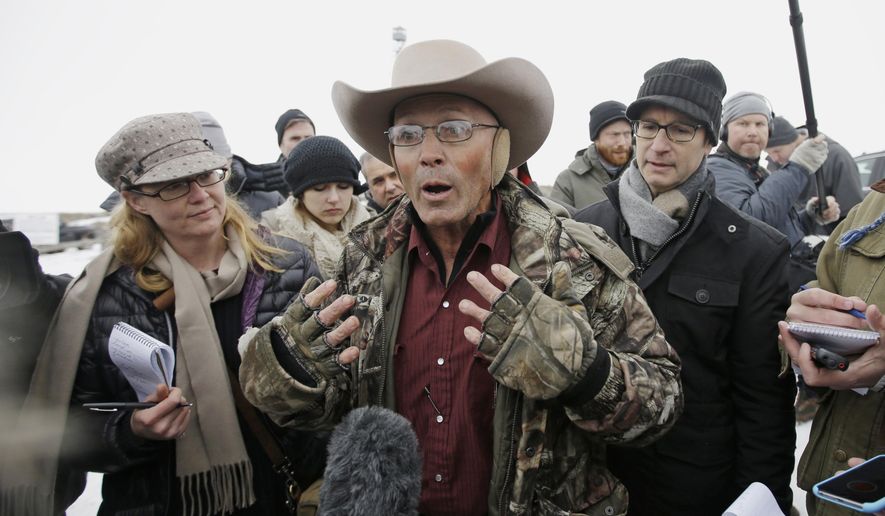 In this Jan. 5, 2016 file photo, Robert &quot;LaVoy&quot; Finicum, center, a rancher from Arizona, talks to reporters at the Malheur National Wildlife Refuge near Burns, Ore. A jury is deliberating whether an FBI agent lied about firing shots at Finicum, a militia leader who participated in the armed takeover of the Oregon wildlife refuge. The Oregonian/OregonLive reports prosecutors and defense lawyers for W. Joseph Astarita made closing arguments and that a jury of three women and nine men began deliberating Thursday afternoon, Aug. 9, 2018. (AP Photo/Rick Bowmer, File)