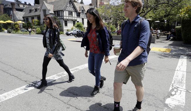 University of California students, from left, Anjali Banerjee, Alice Ma and Tyler Heintz walk near the university&#x27;s campus Wednesday, June 6, 2018, in, Berkeley, Calif. The students who were in Nice, France when a terrorist drove a truck down a promenade killing 83 people, including one of their classmates, have channeled their grief and anger into two nonprofits to fight terrorism.  (AP Photo/Marcio Jose Sanchez)