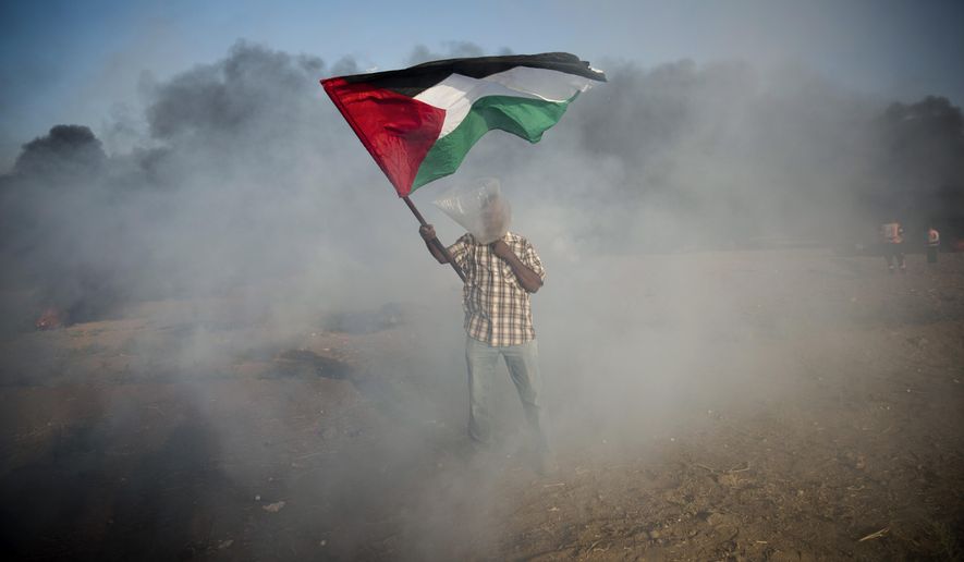 A Palestinian protester wore a plastic bag as protection from teargas during a protest Friday at the Gaza Strip&#39;s border with Israel. (Associated Press/File)