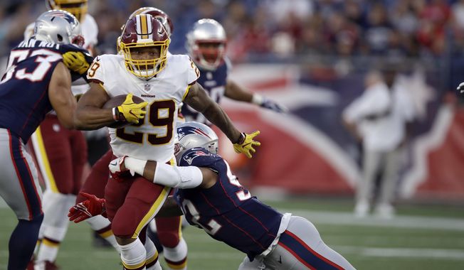 New England Patriots linebacker Elandon Roberts (52) tackles Washington Redskins running back Derrius Guice (29) during the first half of a preseason NFL football game, Thursday, Aug. 9, 2018, in Foxborough, Mass. (AP Photo/Charles Krupa)